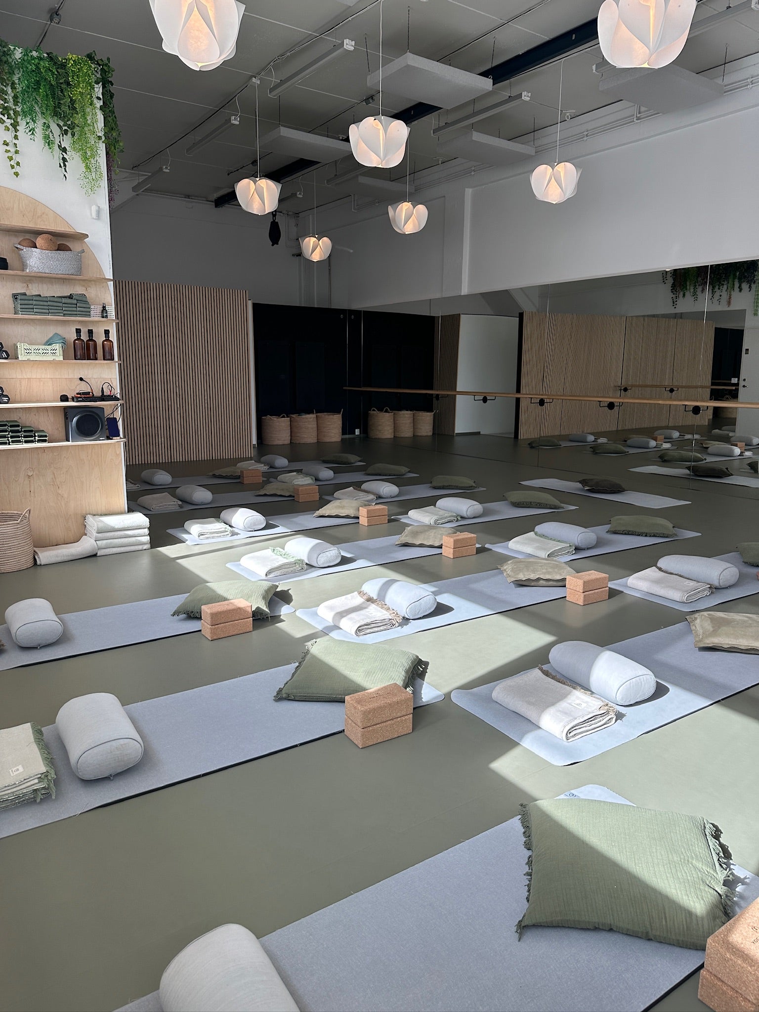 Yoga studio with mats, pillows, and blocks arranged for practice.